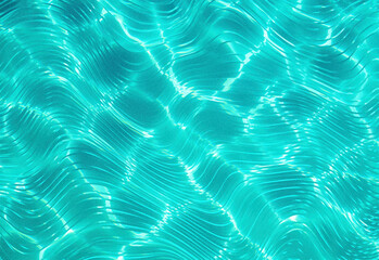 Crystal clear turquoise water surface with sunlit ripples and shimmering reflections, creating a refreshing coastal pool scene ideal for travel, lifestyle, and summer serenity visuals