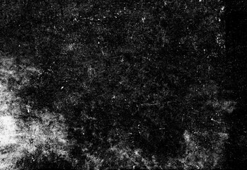 Monochrome grunge texture featuring dark concrete surface with speckled weathering, irregular light patches, and organic noise, ideal as a versatile background for design projects