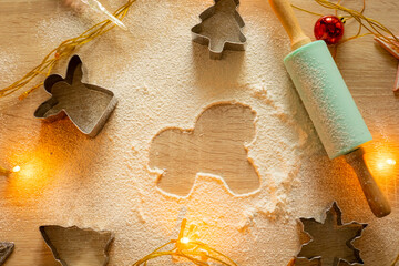 A horse-shaped gingerbread on a table with flour and a rolling pin. Baking Christmas cookies. Christmas background.