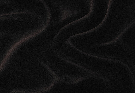 Close up of a dark textured fabric with a velvet-like surface sprinkled with tiny shimmering particles, creating a moody, luxurious background ideal for branding and photography