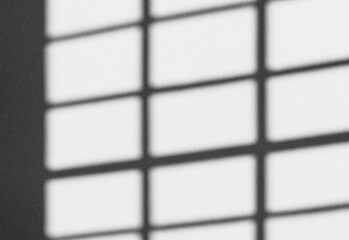 Close up of a square grid pattern in black and white, architectural window pane design with strong contrast and subtle shadows, forming a geometric composition for photography