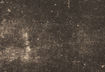 Close up of a dark, gritty textured surface resembling weathered concrete or asphalt with subtle specks, dust, and patina, ideal as a versatile background for design and photography