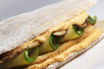 Close up of a vegetarian sandwich with white bread, and zucchini