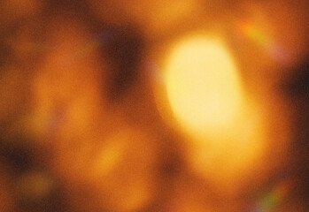 Soft abstract background featuring warm golden bokeh lights and blurred circular orbs in amber tones, evoking cozy ambience, festive atmosphere, and versatile lighting for projects © DesignSells