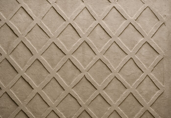 Close-up of a textured geometric lattice pattern on a brown surface with interlocking diamond shapes, tactile grooves, and subtle shadows for versatile industrial backgrounds