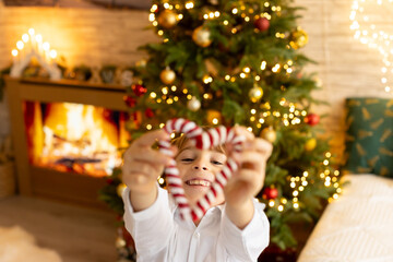 Happy family on Christmas, enjoying some quality time together, kids and adults with pet dog on Christmas eve in decorated home