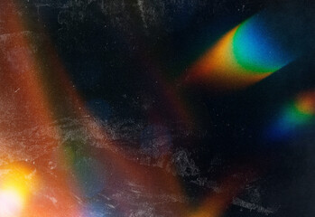 Abstract close up of colorful light refracting through a prism, creating vivid rainbow gradients, soft grain texture, and a dark blue backdrop for design and creative projects