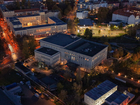 Aerial view of the Berghain nightclub's imposing architecture against the fading twilight, casting long shadows across the urban landscape, Berlin, Berlin, Germany.