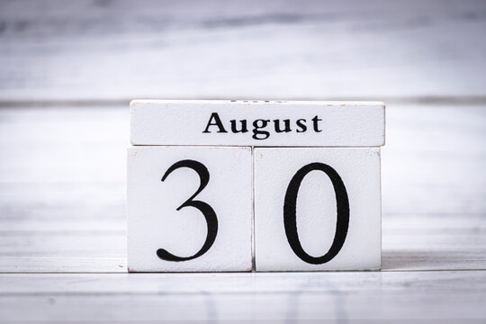 A wooden calendar displaying the date August 30. This visual representation of time enhances any project related to planning, scheduling, or events, creating a sense of organization.