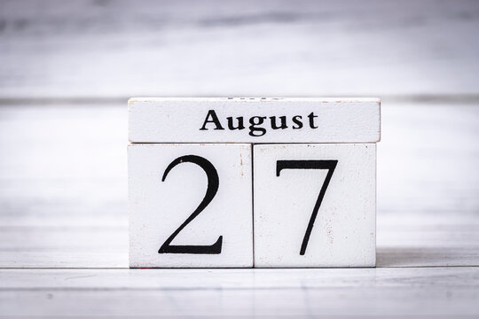 A wooden calendar displaying the date August 27, highlighting the simplicity of organization tools. Ideal for planning, reminders, or seasonal themes.
