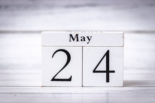 Wooden calendar displaying May 24. This image represents the notion of time, organization, and planning. Suitable for themes of scheduling and lifestyle choices.