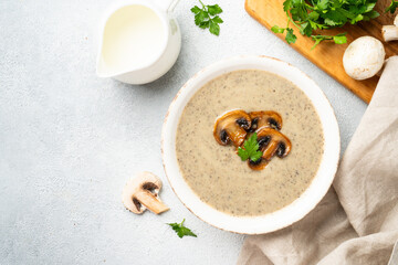 Mushroom soup on white background with ingredients for cooking.