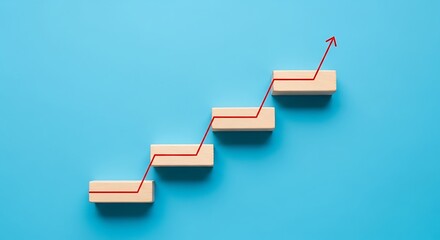 Wooden blocks arranged as steps with arrow, representing business growth