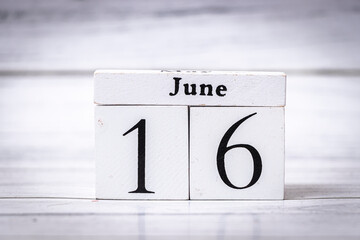 Wooden calendar blocks display the date June 16, symbolizing the mid-month period of June. It can represent time management, scheduling, and calendar themes in various contexts.