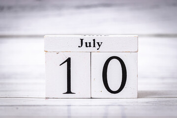 July 10 displayed on a wooden calendar block, representing a specific date. This image captures the...