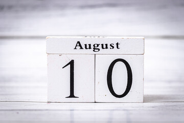Wooden calendar blocks display date August 10. This simple design adds charm to home decor, ideal for events and celebrations, representing mid-summer.