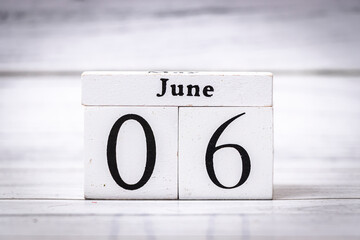 Wooden calendar blocks display June 06, signifying the sixth day of June. Perfect for personalized decorations, events, and lifestyle projects. Ideal for summer themes.