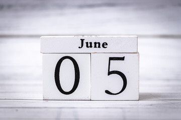 A wooden calendar block shows the date June 05. The minimalistic design and neutral color palette make it suitable for various commercial applications.