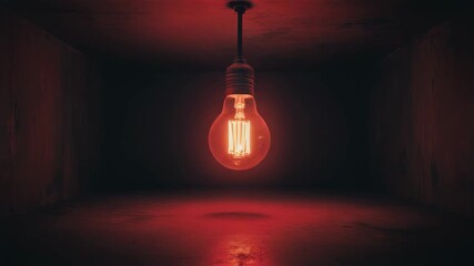 Single glowing incandescent bulb hanging in a dark industrial room casting a red light filament - Powered by Adobe