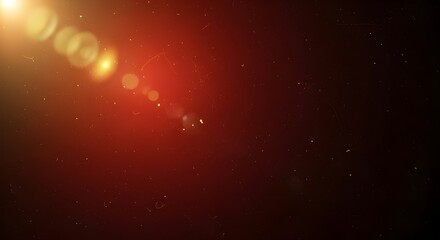 A bright golden lens flare emanates from the upper left, casting warm light and bokeh onto a dark red textured surface.