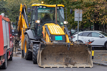 Construction site with industrial machines used in transport industry outside in urban city street
