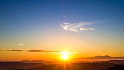Beautiful sunset over rolling hills, with a vibrant sky