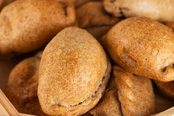 Homemade baked golden pies, closeup.