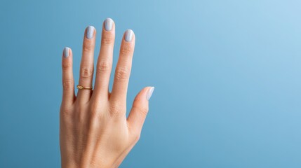 Close-up of a woman's hand displaying a five-finger hurray gesture against a blue background