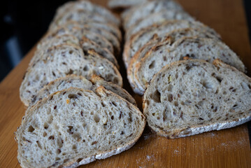 Close-up view of artisan sourdough bread slices arranged neatly on cutting board. Perfect for bakery websites, recipes, and rustic kitchen visuals. 