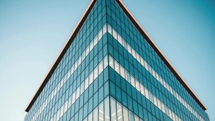 Modern glass skyscraper ascends into clear blue sky, symbolizing corporate growth and ambition 4k high quality footage
