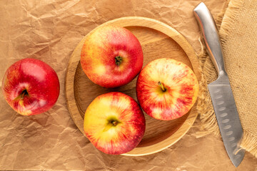 Juicy sweet apples on kraft paper, top view, macro.