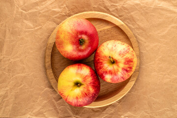 Juicy sweet apples on kraft paper, top view, macro.