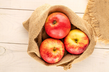 Juicy sweet apples on a wooden table, top view, macro.