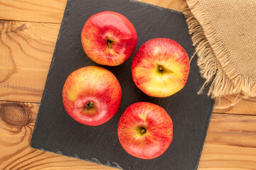 Juicy sweet apples on a wooden table, top view, macro.