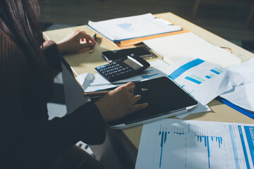 Close-up of businessman's hands making notes, mobiles, chart, desk, office