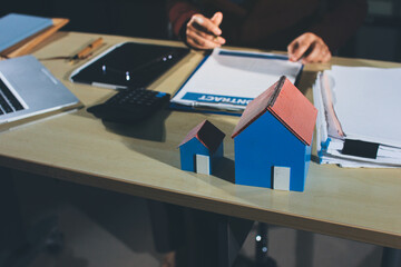 Customer signing a real estate contract in real estate agency.