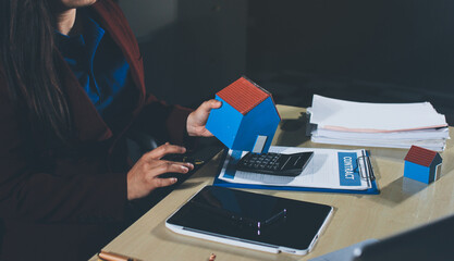 Customer signing a real estate contract in real estate agency.