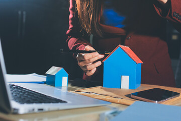 Customer signing a real estate contract in real estate agency.