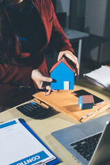 Customer signing a real estate contract in real estate agency.