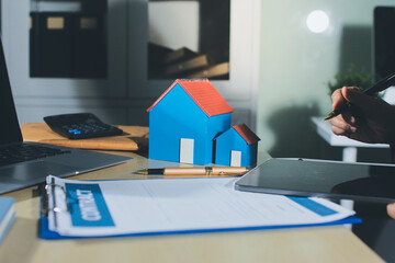 Customer signing a real estate contract in real estate agency.