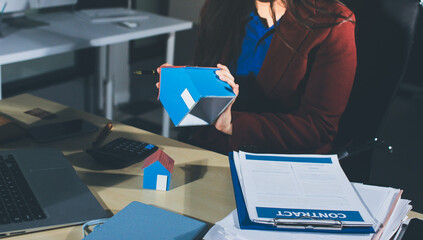 Customer signing a real estate contract in real estate agency.