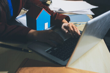 Customer signing a real estate contract in real estate agency.