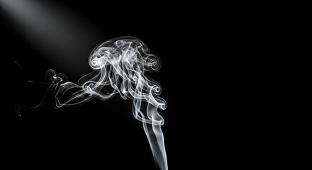 Wispy white smoke curls upwards illuminated by a dramatic spotlight against a dark background