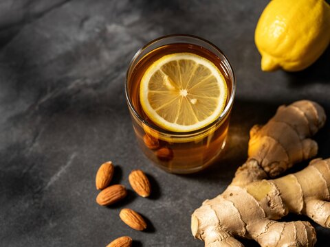 Hot Lemon Ginger Tea with Almonds on Dark Background | Healthy Herbal Drink Concept