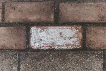 Unnoticed marks reveal stories on cobblestone paths in a quiet town