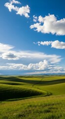 Obraz premium Rolling Green Hills Under a Bright Blue Sky with Fluffy Clouds.
