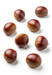 Fresh Chestnuts on White Background - A cluster of fresh, raw chestnuts scattered on a white background, ready for roasting or other culinary uses
