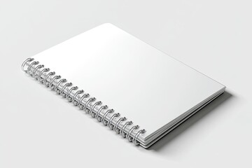 Blank white spiral-bound notebook, angled slightly, on a pale background