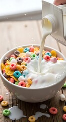 Colorful Cereal Bowl with Milk Pouring In for Breakfast.