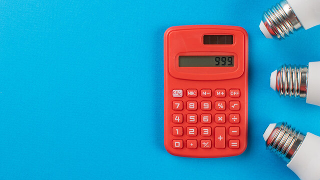 Red Calculator with Light Bulbs on Blue Background Reflecting Innovation and Efficiency